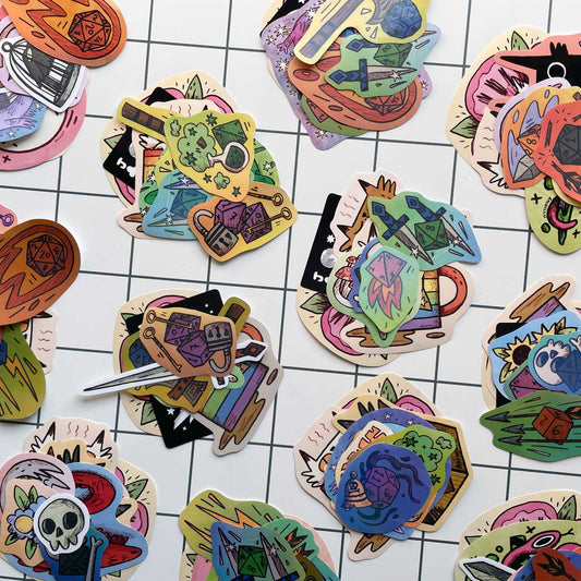 Colorful die-cut stickers with various designs on a grid background